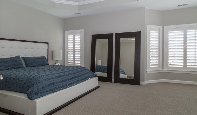 White shutters in a minimalist bedroom in Fort Lauderdale.